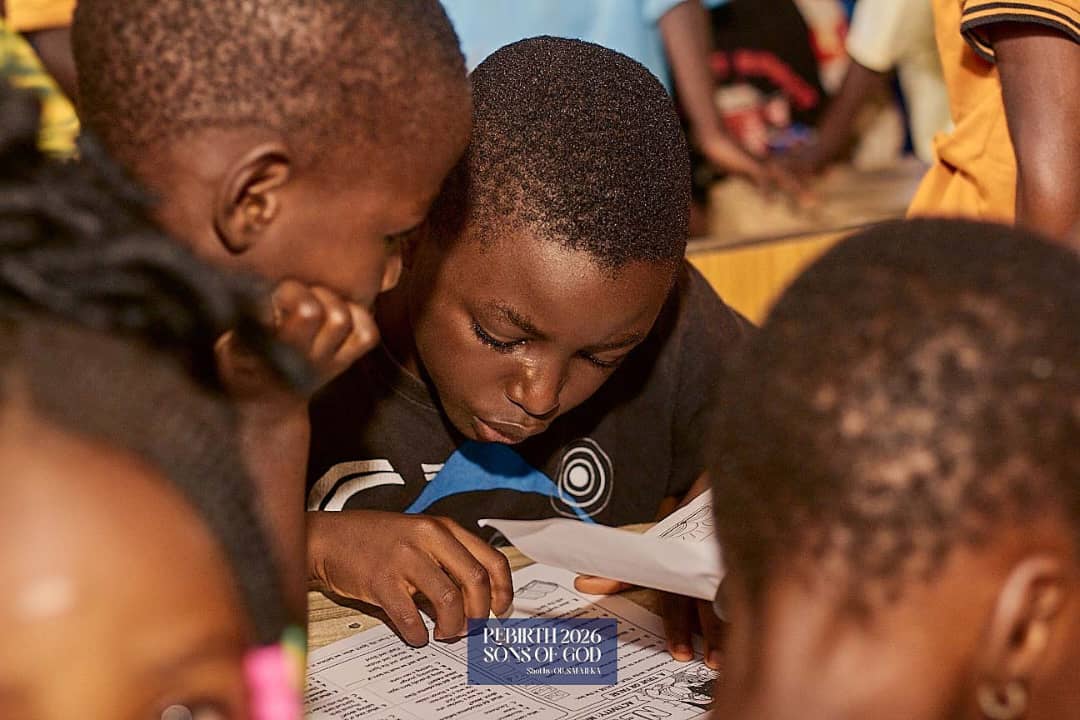 Children reading and working together around a table.