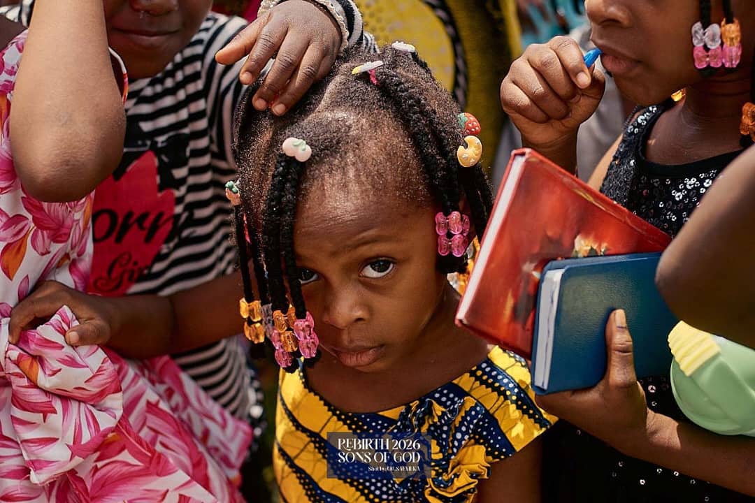 Children gathered closely with books in their hands.