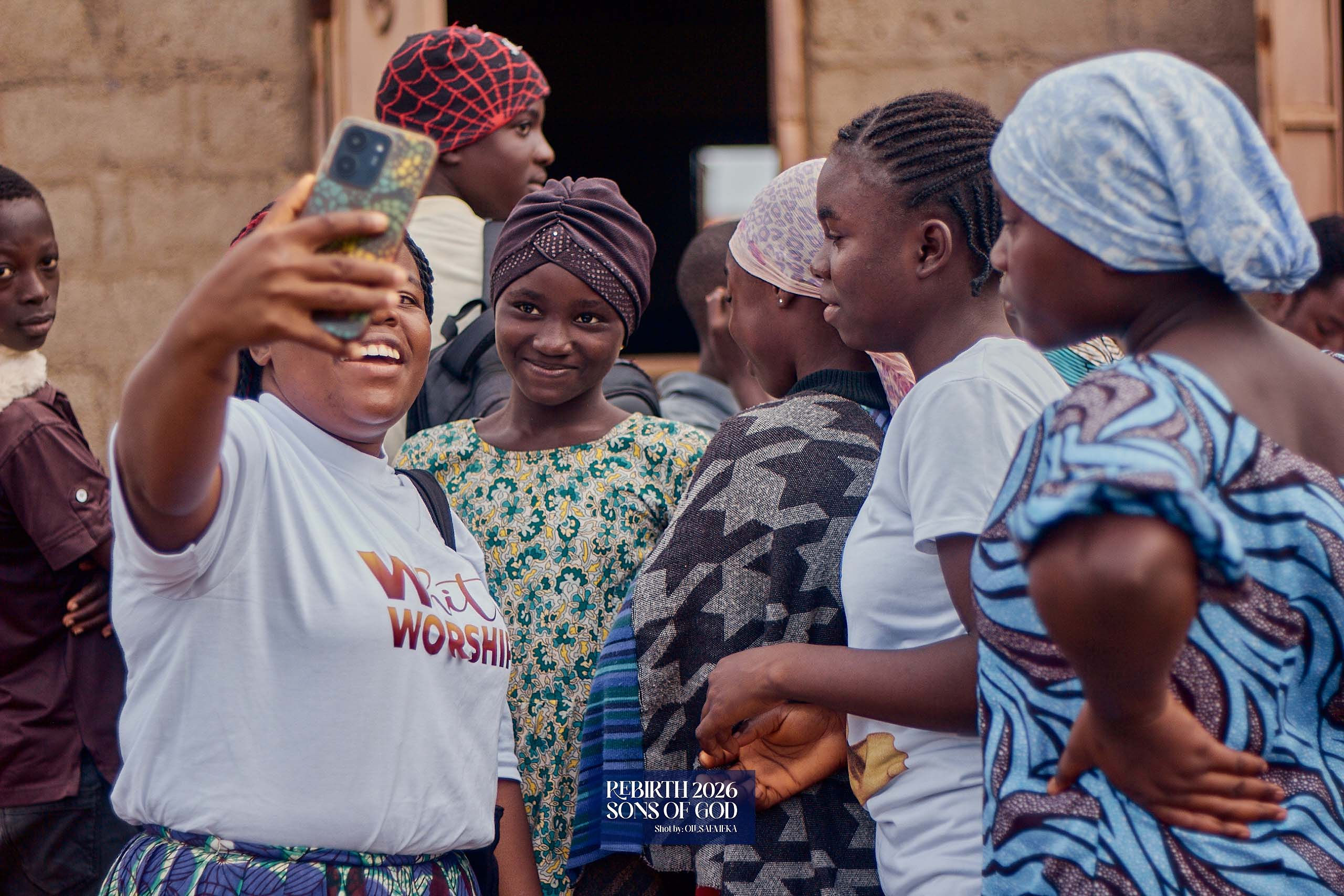 An adult and children gathering for a photograph together.