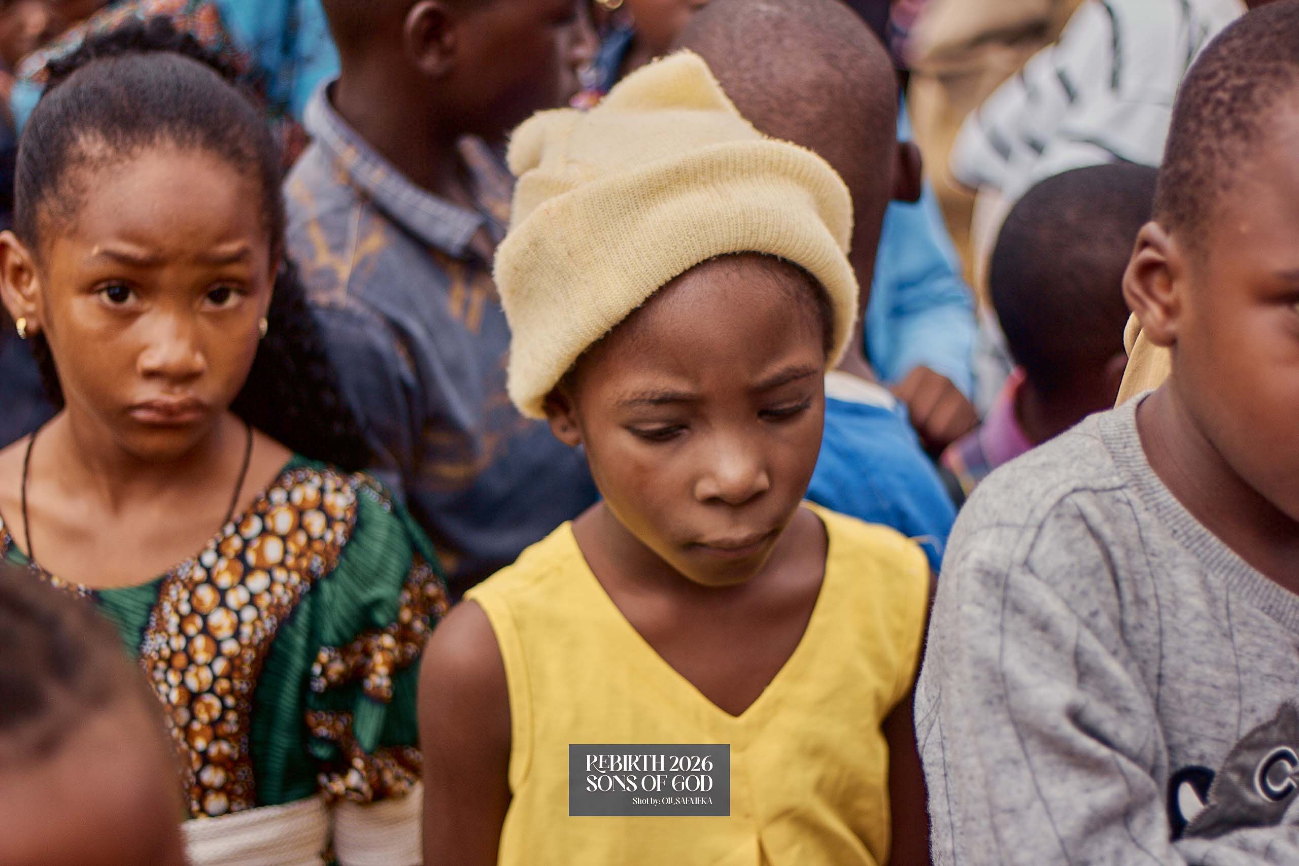 Children standing together outdoors.