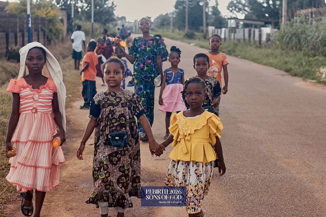 Children walking together, with two holding hands.