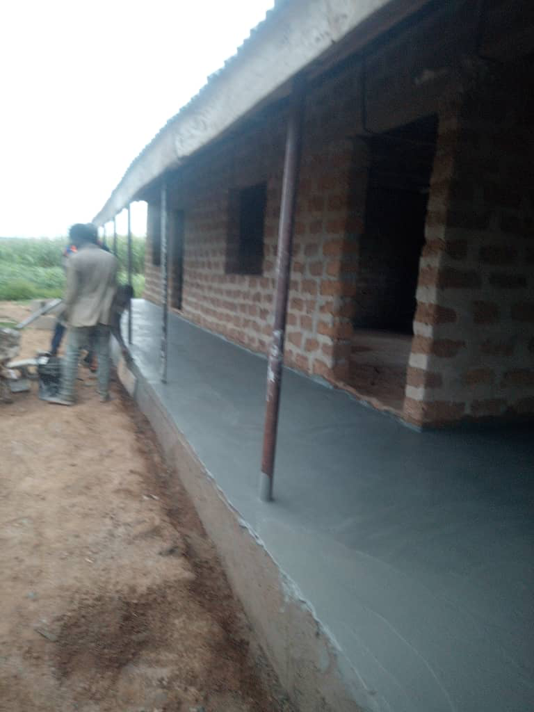 Fresh flooring along the covered walkway outside the school classrooms.